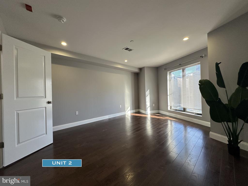 1606 Point Breeze Avenue Philadelphia, PA 19145 - Photo 22 of 35 a view of an empty room with wooden floor and a window