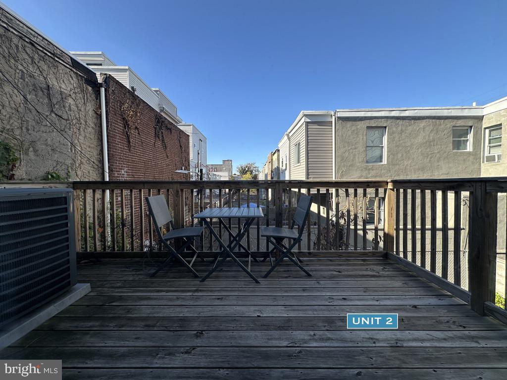 1606 Point Breeze Avenue Philadelphia, PA 19145 - Photo 23 of 35 a view of a roof deck with table and chairs with wooden floor and fence