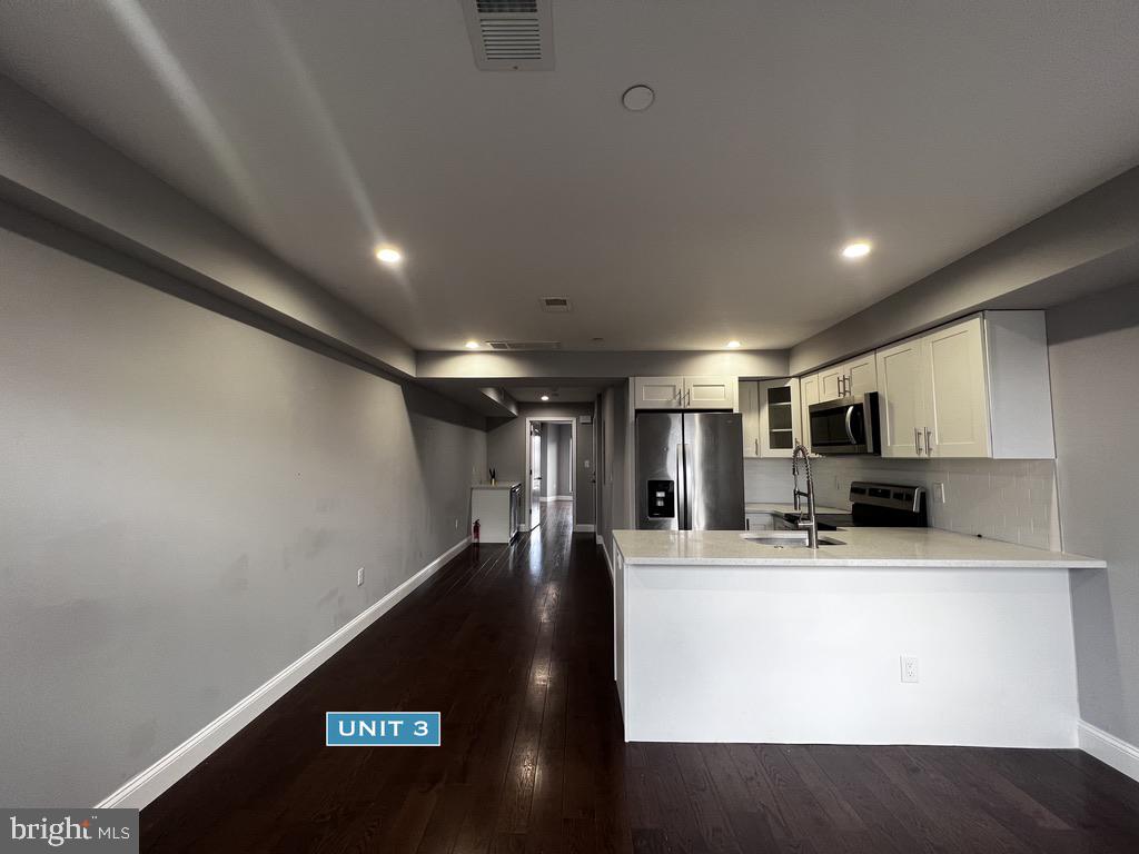 1606 Point Breeze Avenue Philadelphia, PA 19145 - Photo 24 of 35 a view of a kitchen with a microwave and cabinets