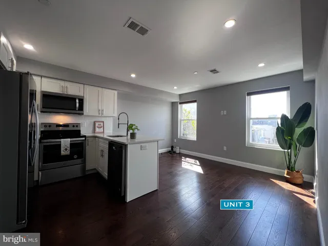 a view of kitchen with refrigerator and window
