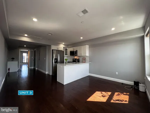 a bathroom with a sink a toilet a mirror and bathtub