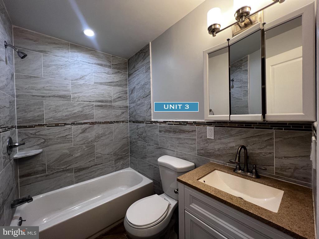 1606 Point Breeze Avenue Philadelphia, PA 19145 - Photo 27 of 35 a bathroom with a sink a toilet a mirror and bathtub