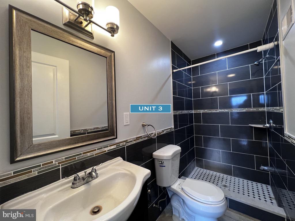 1606 Point Breeze Avenue Philadelphia, PA 19145 - Photo 29 of 35 a bathroom with a sink a toilet and a mirror