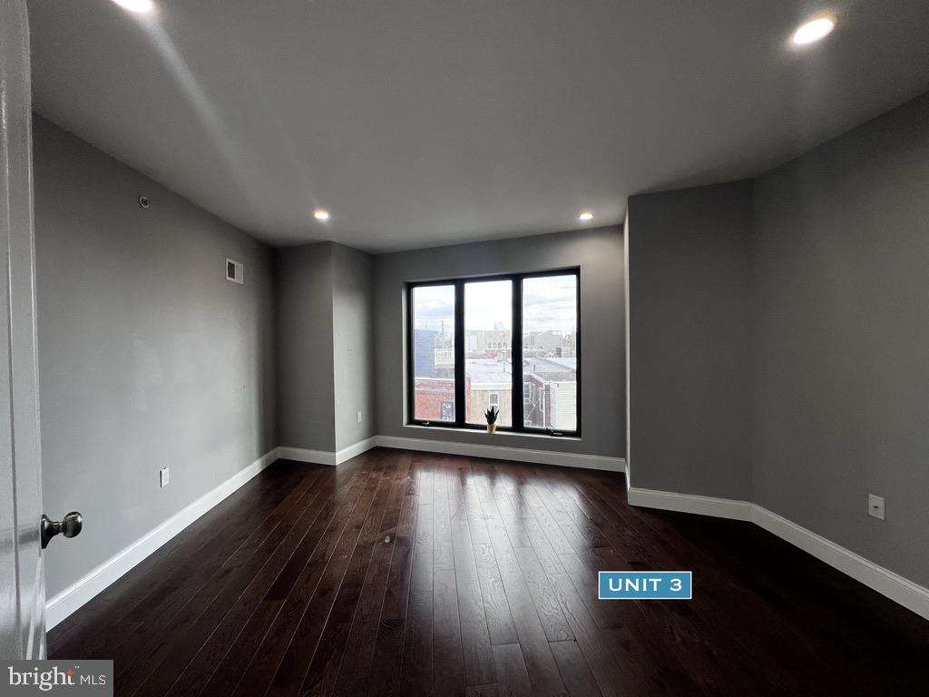1606 Point Breeze Avenue Philadelphia, PA 19145 - Photo 31 of 35 a view of an empty room with wooden floor and a window