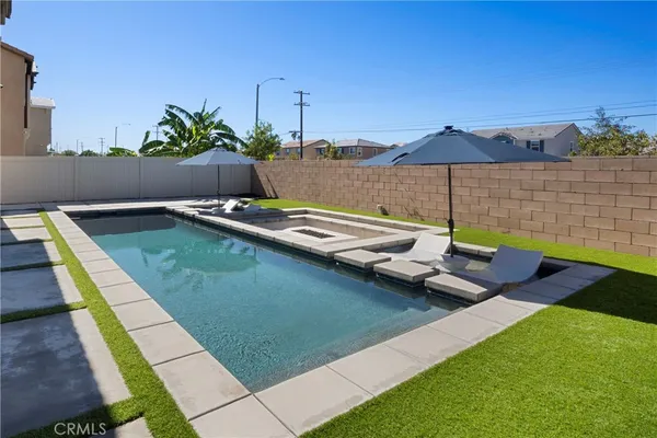 a view of a backyard with a table and chairs