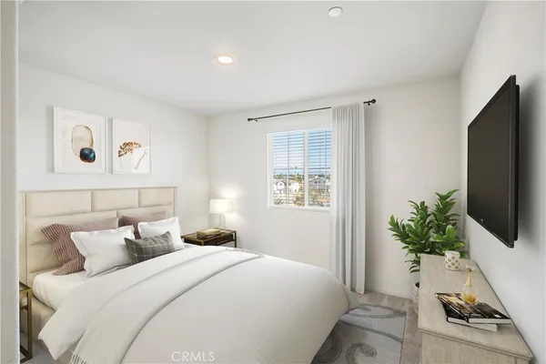 a bedroom with a bed and a flat screen tv