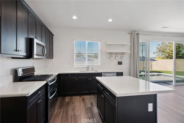 a kitchen with a sink stove and microwave