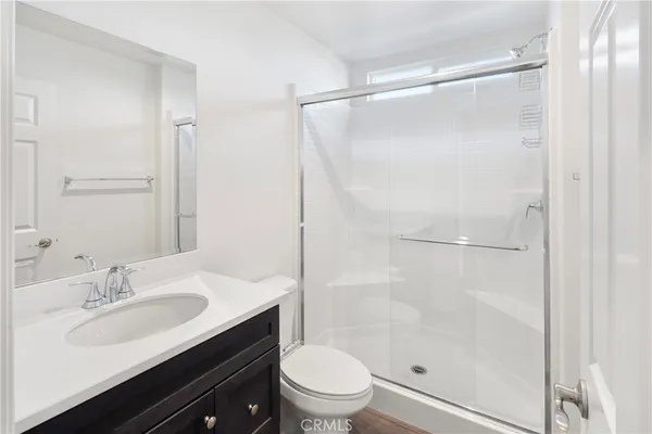 a bathroom with a sink toilet double vanity and shower