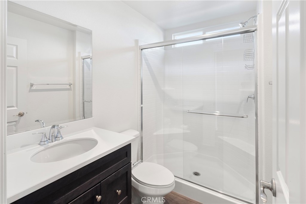 9605 Bonsai Lane Riverside, CA 92508 - Photo 18 of 30 a bathroom with a sink toilet double vanity and shower