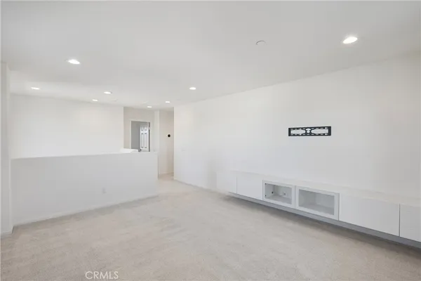 an empty room with a empty space and windows