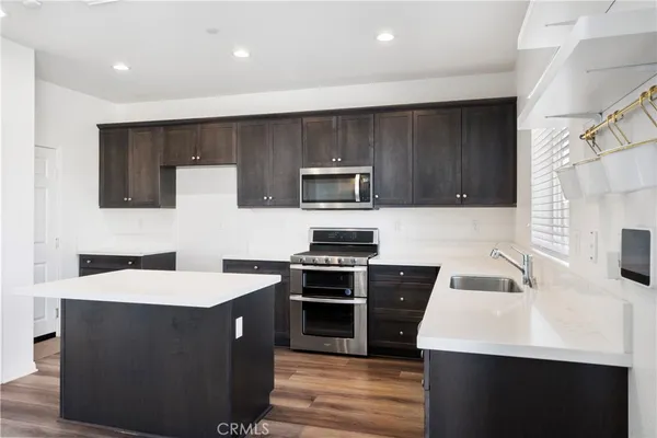 a kitchen with a sink appliances and cabinets