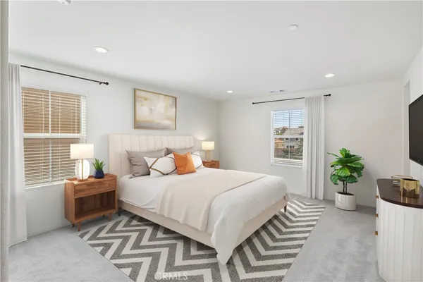 a bedroom with a bed and a potted plant