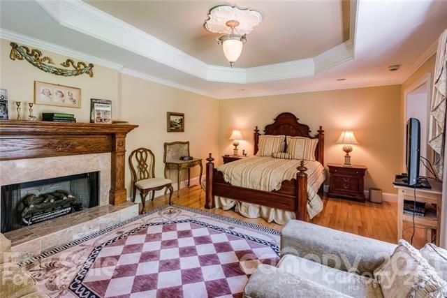 2932 High Ridge Road Charlotte, NC 28270 - Photo 13 of 26 a bedroom with a bed and a fireplace