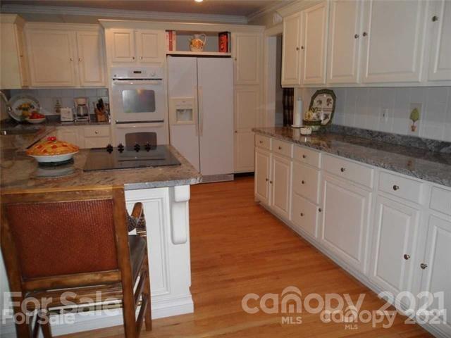 2932 High Ridge Road Charlotte, NC 28270 - Photo 6 of 26 a kitchen with stainless steel appliances granite countertop a stove a sink and a refrigerator