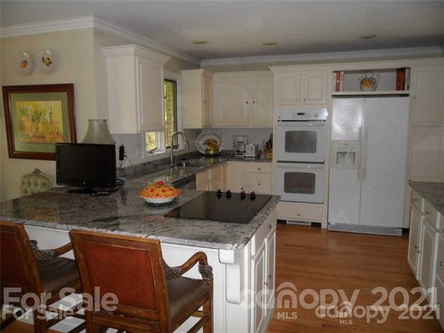 2932 High Ridge Road Charlotte, NC 28270 - Photo 7 of 26 a kitchen with stainless steel appliances granite countertop a stove and a refrigerator
