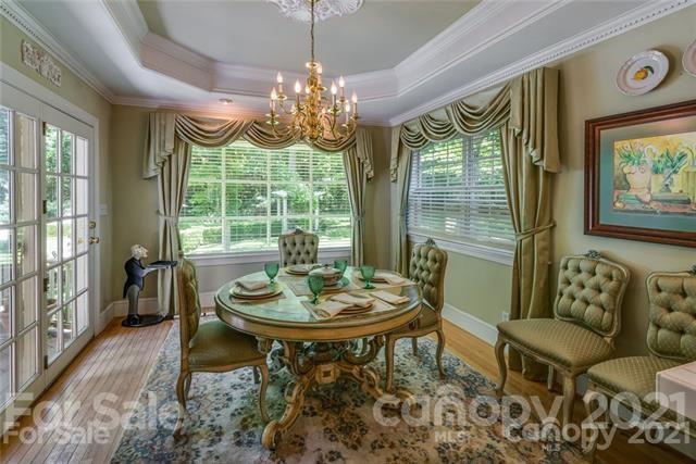 2932 High Ridge Road Charlotte, NC 28270 - Photo 8 of 26 a dining room with furniture a rug and a chandelier