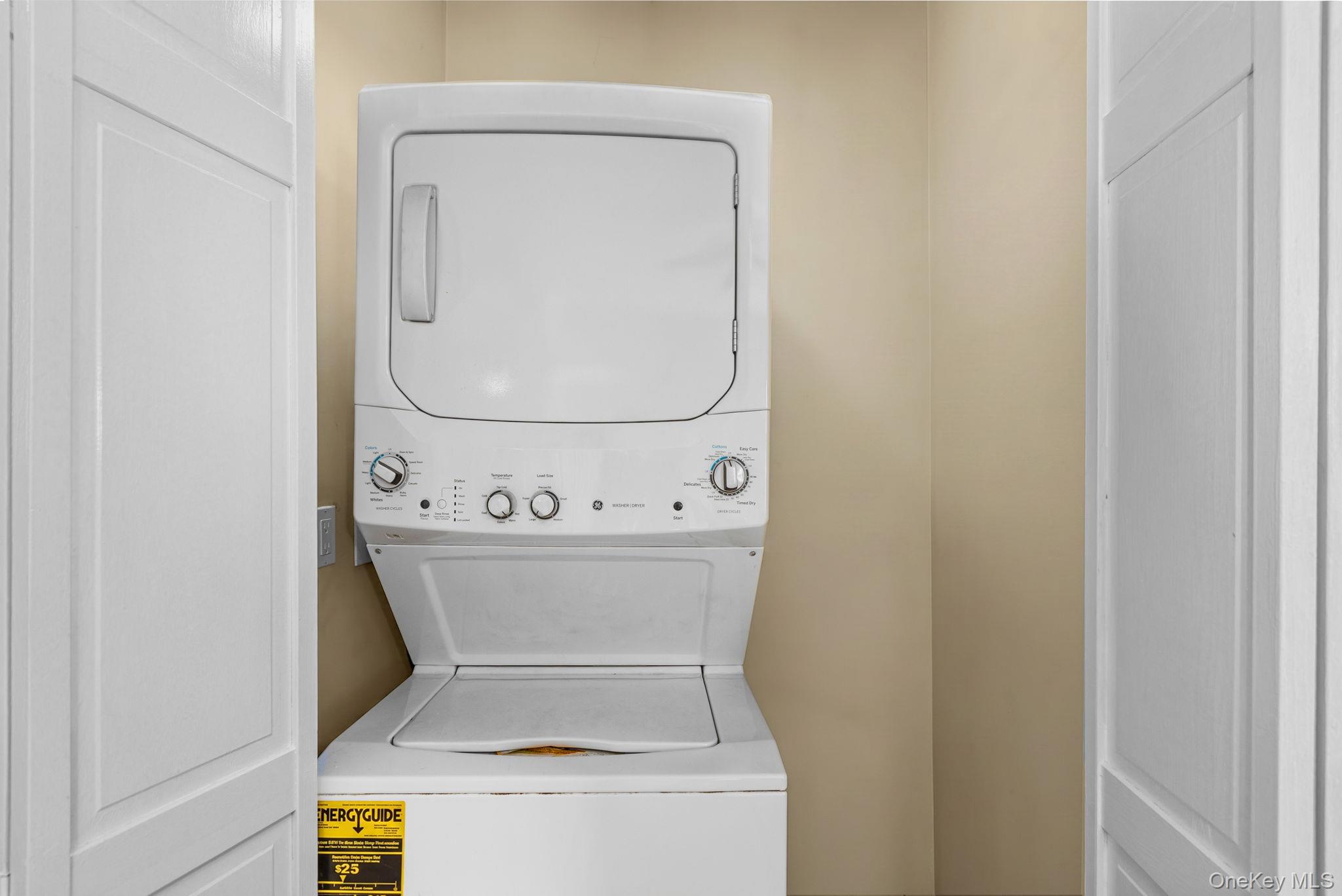 10 Batavia Road Patterson, NY 12563 - Photo 24 of 42 White stacked washer and dryer unit, featuring a top-load washer and front-load dryer