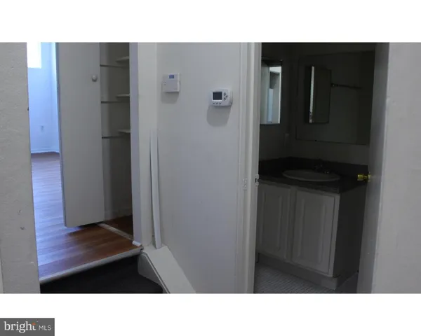 a bathroom with a sink a mirror and a shower