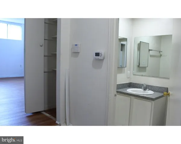 a bathroom with a toilet a sink and a mirror