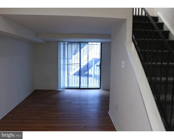a view of an empty room and wooden floor