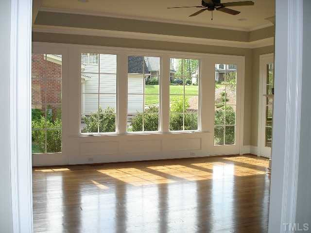 5326 Landguard Drive Raleigh, NC 27613 - Photo 9 of 17 Lovely family room is adjacent to kitchen. Features gorgeous hardwoods, elegant tray ceiling,large windows to let in natural light, fireplace and built-ins. Den/Family/Great Room