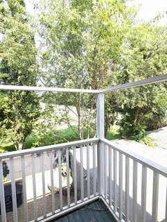 a balcony with trees in front of it