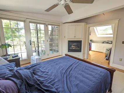 a bedroom with a bed and a fireplace