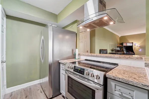 a kitchen with a stove and a refrigerator