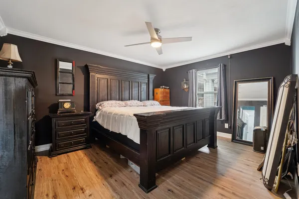 a bedroom with a bed and wooden floor