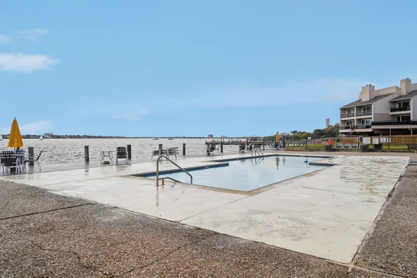 a view of a swimming pool with a lounge chair
