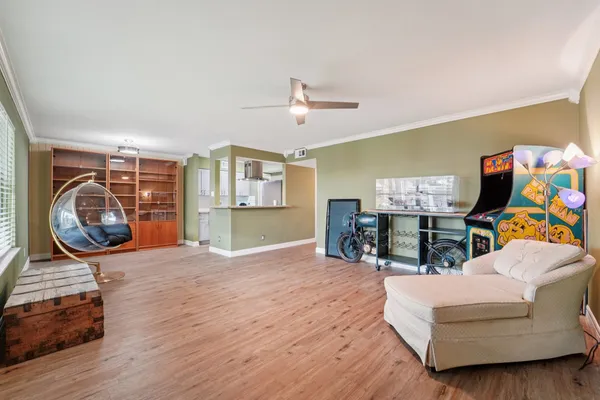 a living room with furniture and a wooden floor