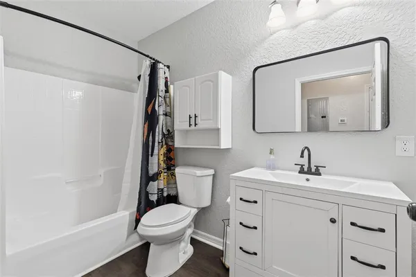 a bathroom with a toilet a sink and a mirror
