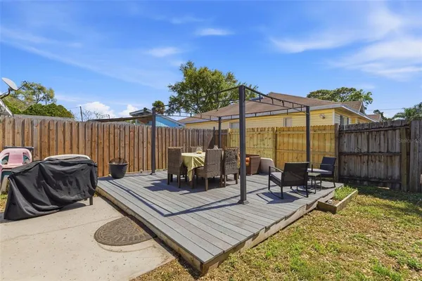 a view of a roof deck with furniture
