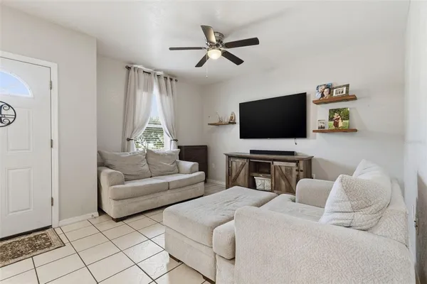 a living room with furniture and a flat screen tv
