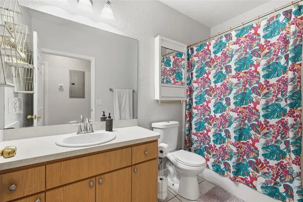 a bathroom with a sink mirror vanity and toilet