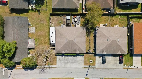 an aerial view of multiple houses with street