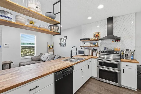 a kitchen with a sink stainless steel appliances and cabinets