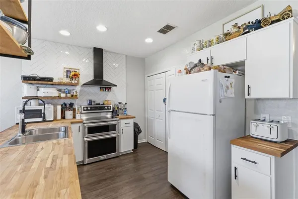 a kitchen with stainless steel appliances a refrigerator stove and sink