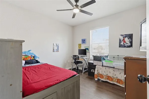 a bedroom with bed and a window