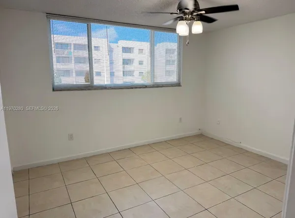 an empty room with a chandelier fan