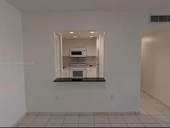 a kitchen with stainless steel appliances a refrigerator and a stove top oven