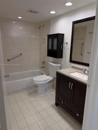 a bathroom with a sink a toilet a mirror and shower