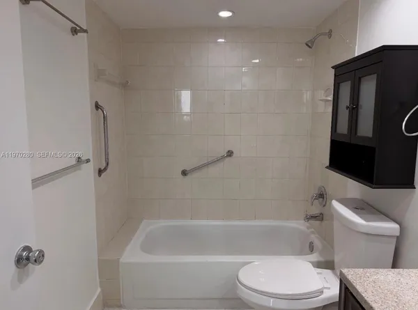 a bathroom with a toilet and a bathtub