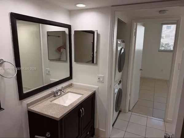 a bathroom with a sink a mirror and shower