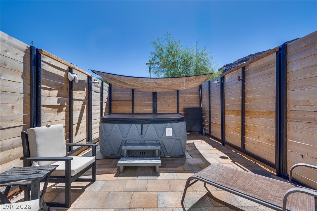 524 Swallow Cove Boulder City, NV 89005 - Photo 40 of 58 A private, paved courtyard retreat, ideal for unwinding, features a spa and ample space for lounging under the open sky.