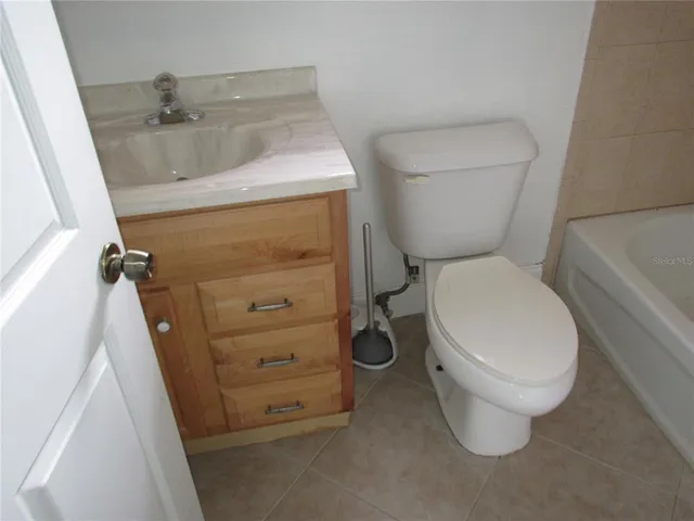 a white toilet sitting next to a sink
