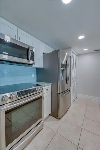 a kitchen with cabinets and stainless steel appliances