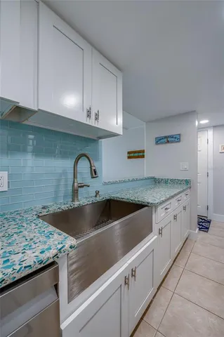 a kitchen with granite countertop a sink and a stove