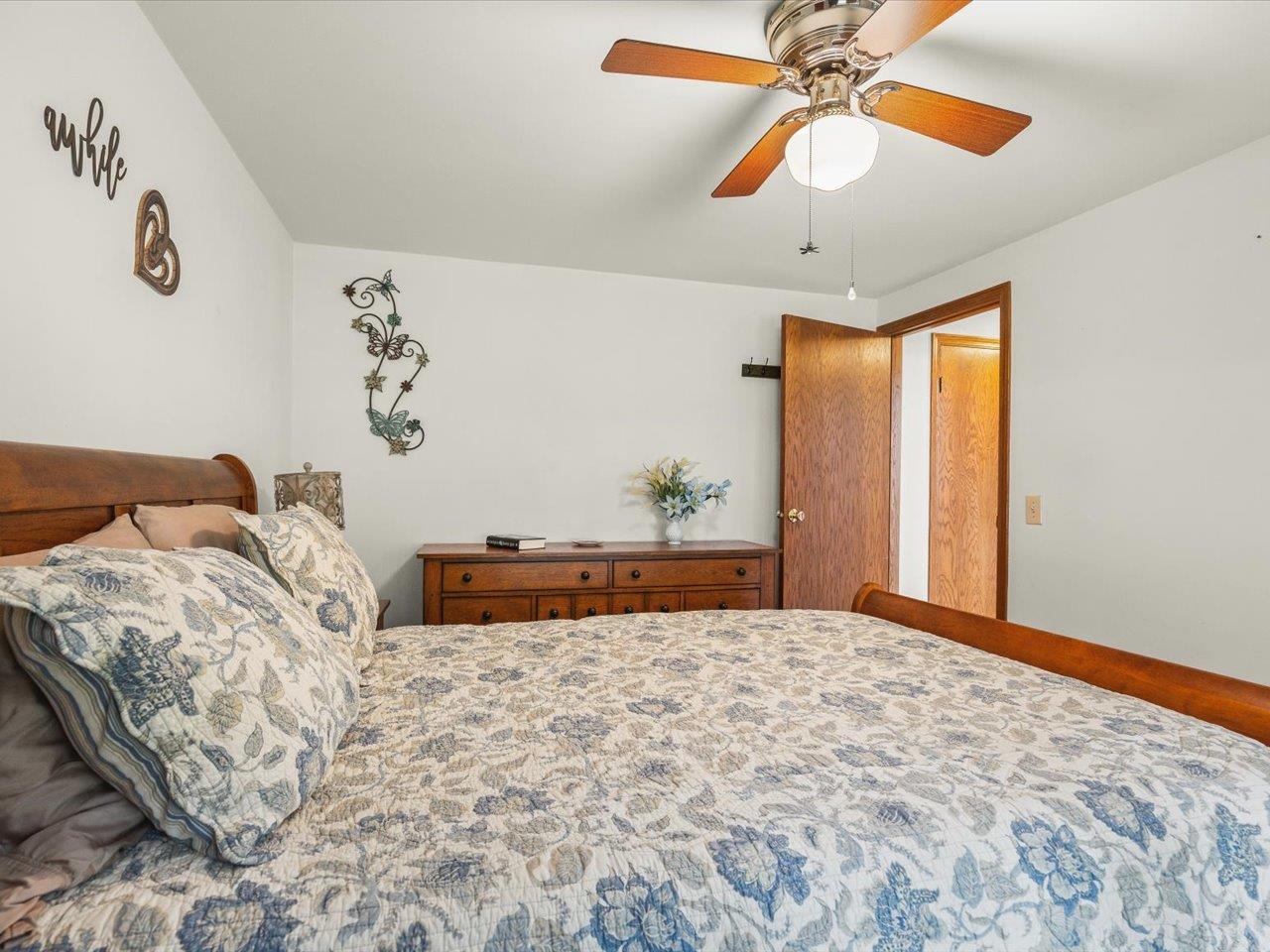 8500 Manchester Road Capron, IL 61012 - Photo 32 of 51 a bedroom with a large bed and a chandelier