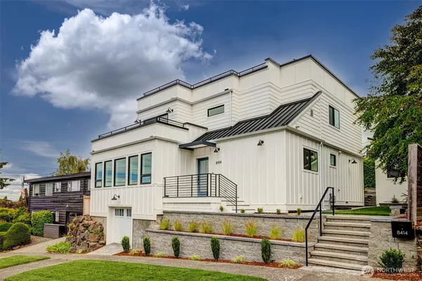 a view of a white building among the yard and large windows